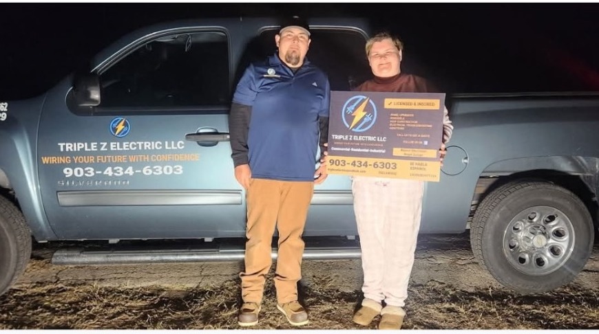 Angel Zuñiga with the winner of the Triple Z Electric Bill Giveaway standing next to the company truck